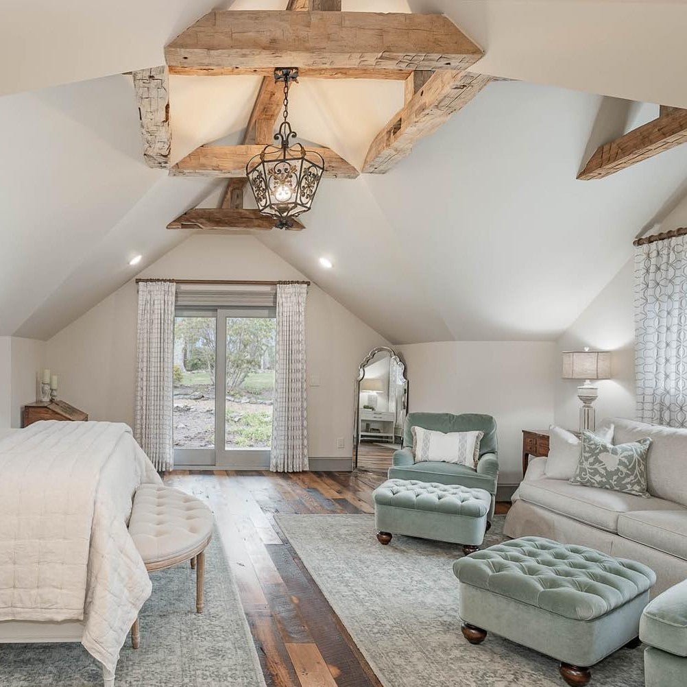 wood beam ceiling bedroom with iron lantern pendant and aqua seating