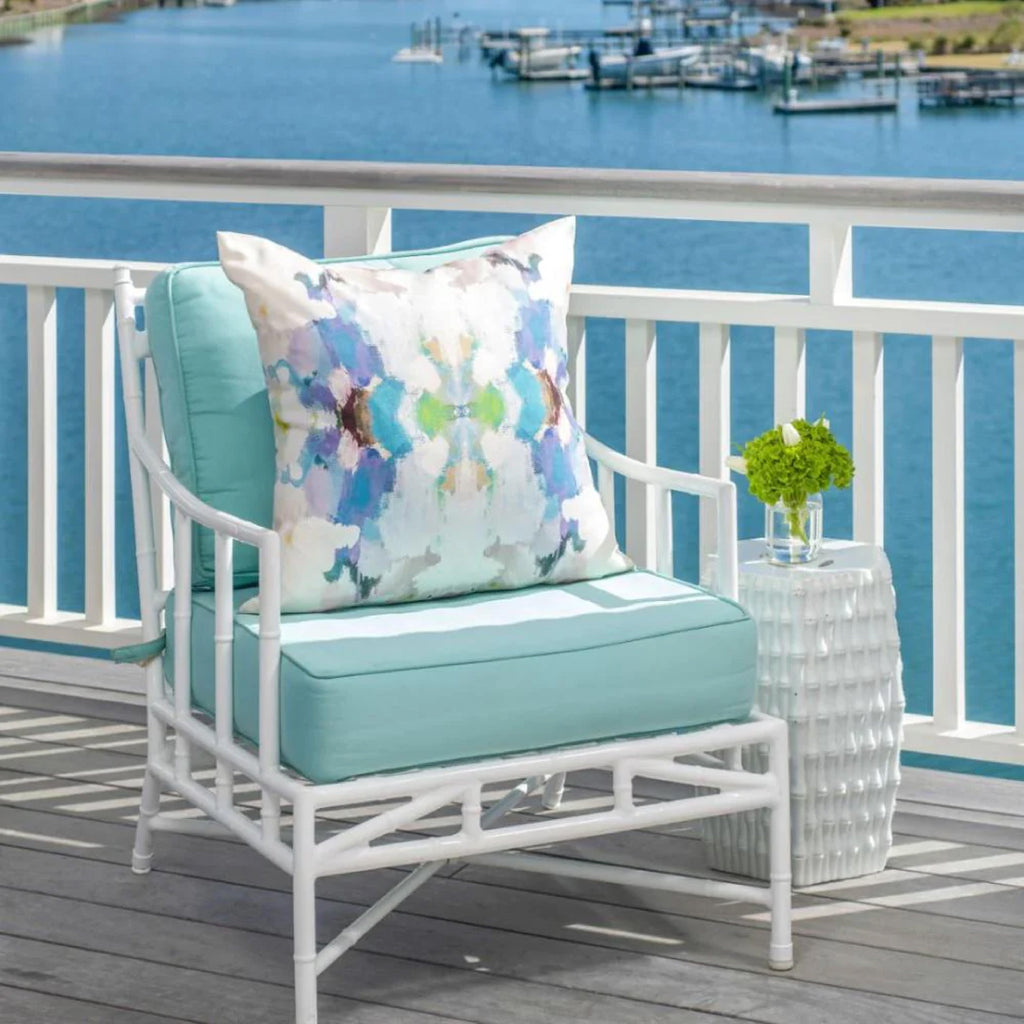 white rattan outdoor seat with blue cushions 