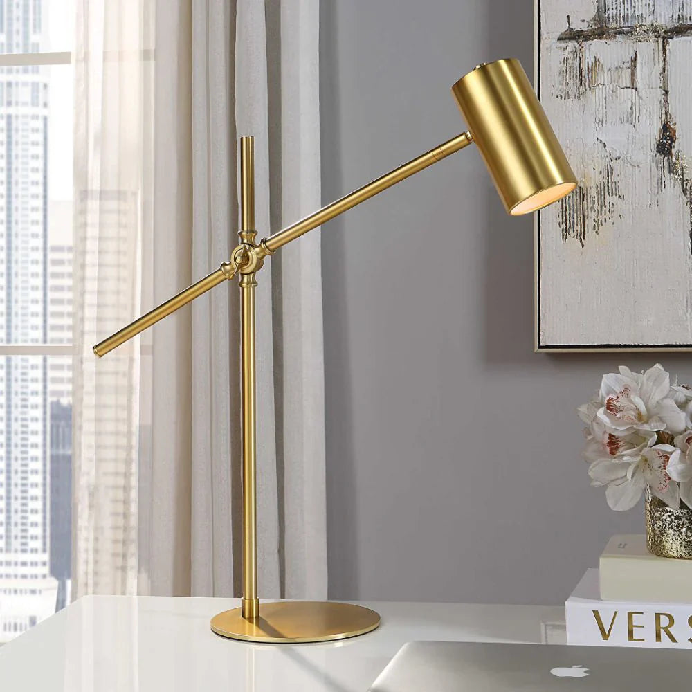 brass swing arm desk lamp on desk