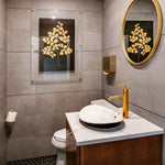 Modern bathroom with a round mirror, gold faucet, and Barloga Studios' "Golden Duck on Kozo Noire Photography Art," elegantly displayed within an archival wood frame, set against a dark background.