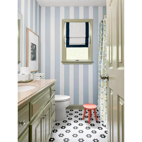 blue and white striped wallpaper bathroom with black and white tile floor and floral blue shower curtain