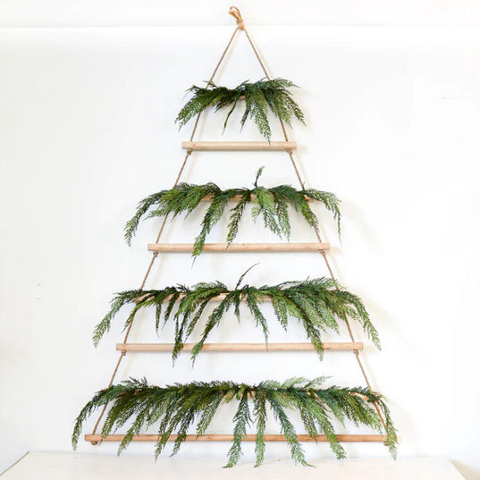 The Sugarboo & Co. Tall Hanging Wood + Jute Tree Display is a minimalist tree with fir branches and fairy lights.