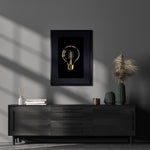 Modern living room with a dark grey sideboard, decorative vases, books, and Barloga Studios' Golden Owl Kozo Noire Photography Art in an archival wood frame on the wall.