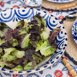 blue and white ceramic serving bowl with salad greens