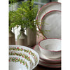 Simple Round Red Rim Melamine Dinner Plates (set of 4) from Always Relish, with elegant red and green designs, are paired with small vases filled with greenery on a wooden table.