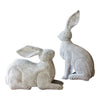 Kalalou's whimsical Rustic Metal Rabbits set on a wooden table, below a vibrant tulip picture.