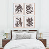 A neatly made bed with patterned pillows is adorned with the Pressed Foliage Prints by Napa Home & Garden, arranged in a set of four above it. The room features white walls, nightstands, and a light wood frame accentuating the artwork.