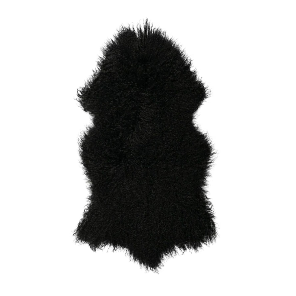 An irregularly shaped Tibetan Longwool Sheepskin Black Pelt Rug from Auskin, featuring soft and dense fur.