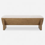 Uttermost's Wedged Bench boasts a chunky wood design with a beige cushioned top and an elegant faux sheepskin seat, set against a white background.