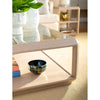 Loom Small Bowl by Villa & House on a beige rug in the living room, accompanied by a glass coffee table with a hand-crafted metal frame, ceramic vase, and books.